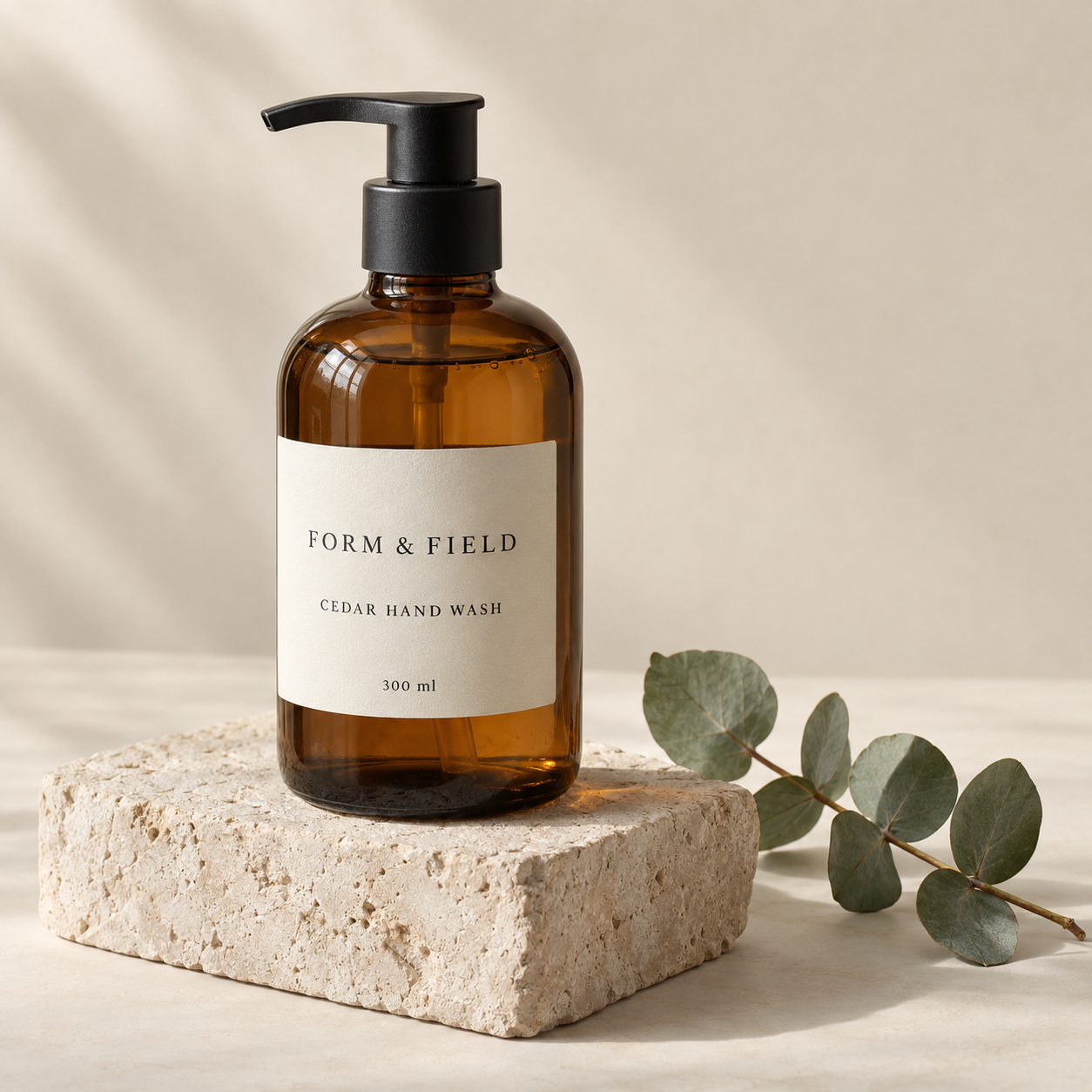 Illustrative amber soap bottle with exact label lettering on a limestone display block